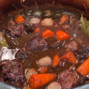 Slow cooked beef shin with red wine, baby carrots & onions