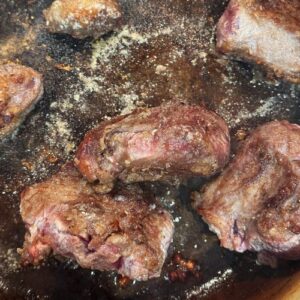 Slow cooked beef shin with red wine, baby carrots & onions