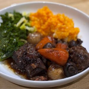 Slow cooked beef shin with red wine, carrots & baby onions