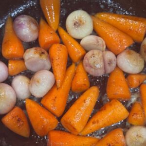 Slow cooked beef shin with red wine, baby carrots & onions