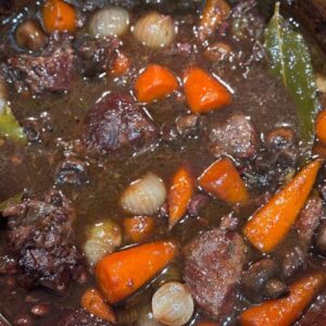 Slow cooked beef shin with red wine, baby carrots & onions
