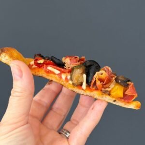 Slice of Truly Yummy Pizza with a thin and crispy base and lots of dairy free toppings