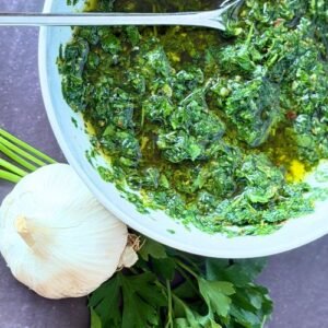 Vibrant green and herby Truly Yummy Chimichurri Sauce with garlic and fresh herbs