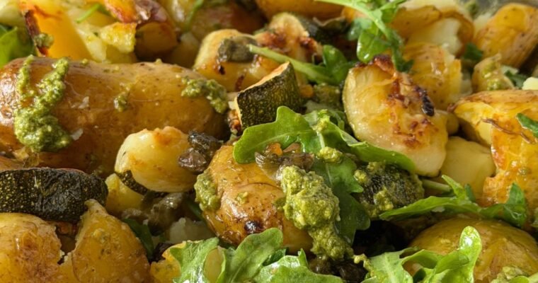 Roasted Jersey Royals, Courgette and capers dressed in fresh green pesto served with wild rocket.