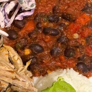 Truly Yummy Spicy Black Beans served alongside pulled pork, rice, sliced avocado and Truly Yummy zesty slaw